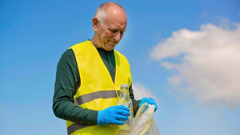 An old man is busy in collecting plastic waste items, endorsing waste management initiatives